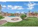 Landscaped backyard with lush green grass, a pool, and covered pergolas perfect for relaxation at 6927 Adobe Villa Ave, Las Vegas, NV 89142