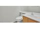 Half bath with toilet, sink and wood cabinet at 6927 Adobe Villa Ave, Las Vegas, NV 89142