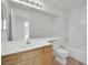 Bright bathroom featuring a bathtub, shower, toilet, and a sink vanity with wood cabinets at 6927 Adobe Villa Ave, Las Vegas, NV 89142