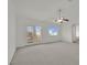 Light-filled bedroom with plush carpeting, access to a balcony, and a bright, sunny window at 6927 Adobe Villa Ave, Las Vegas, NV 89142
