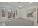 Inviting room with double doors and tile flooring leads to a staircase, blending comfort with architectural details at 6927 Adobe Villa Ave, Las Vegas, NV 89142