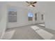 Bright bedroom with neutral carpeting, a ceiling fan, and large mirrored closet doors at 6927 Adobe Villa Ave, Las Vegas, NV 89142