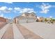Wide driveway leads to a home with a three-car garage at 6927 Adobe Villa Ave, Las Vegas, NV 89142