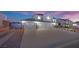 Home with a large driveway, lush landscaping, and a three-car garage at 6927 Adobe Villa Ave, Las Vegas, NV 89142