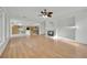 Open concept living room with wood floors and decorative fireplace with kitchen at 6927 Adobe Villa Ave, Las Vegas, NV 89142