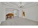 Spacious living room with high ceilings, chandelier, and a grand piano, perfect for entertaining guests at 6927 Adobe Villa Ave, Las Vegas, NV 89142