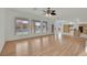 Living room with wood floors, multiple windows and access to the kitchen at 6927 Adobe Villa Ave, Las Vegas, NV 89142