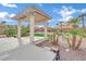 View of the pergola with its landscaped surroundings on a well-maintained lawn and blue skies above at 6927 Adobe Villa Ave, Las Vegas, NV 89142
