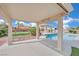Inviting backyard pool area with a covered patio, pergola, and lush landscaping at 6927 Adobe Villa Ave, Las Vegas, NV 89142