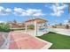 Backyard oasis featuring lush landscaping, a pool and a covered pergola, ideal for entertaining at 6927 Adobe Villa Ave, Las Vegas, NV 89142