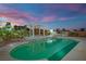 Inviting pool area at twilight, featuring a pergola and outdoor grill, ideal for evening swims at 6927 Adobe Villa Ave, Las Vegas, NV 89142