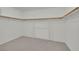 Spacious walk-in closet with neutral carpeting and wooden racks for storage at 6927 Adobe Villa Ave, Las Vegas, NV 89142