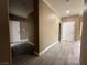 Hallway with multiple white doors and hardwood floors at 7062 Russell Ranch Ave, Las Vegas, NV 89113
