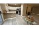 Open-concept kitchen featuring white cabinets, a breakfast bar, and stainless steel appliances at 7062 Russell Ranch Ave, Las Vegas, NV 89113