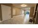 Open floor plan with hardwood floors leading to the front door and sliding patio doors at 7062 Russell Ranch Ave, Las Vegas, NV 89113