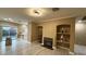 Open living room featuring a fireplace, built-in shelving, and a modern light fixture at 7062 Russell Ranch Ave, Las Vegas, NV 89113
