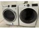 Close-up of a modern GE washer and dryer set with digital controls, a modern convenience at 7062 Russell Ranch Ave, Las Vegas, NV 89113
