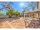 Spacious backyard with mature trees and a covered patio, perfect for outdoor gatherings and relaxing under shade at 7176 Fenway Ave, Las Vegas, NV 89147