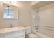 A bathroom featuring a shower and bathtub, along with a vanity and toilet at 7176 Fenway Ave, Las Vegas, NV 89147