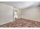 Comfortable carpeted bedroom with an entrance to a hallway at 7176 Fenway Ave, Las Vegas, NV 89147