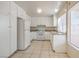 Bright kitchen featuring white cabinets, granite countertops, white appliances, and tile flooring at 7176 Fenway Ave, Las Vegas, NV 89147