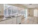 Galley kitchen with stainless steel sink and faucet, double windows with outdoor views and white appliances at 7176 Fenway Ave, Las Vegas, NV 89147