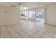 Bright living room featuring tile flooring, sliding glass doors and views to the kitchen and backyard at 7176 Fenway Ave, Las Vegas, NV 89147
