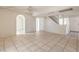 Open living room with tile flooring and stairway to second level at 7176 Fenway Ave, Las Vegas, NV 89147
