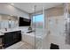 Modern bathroom featuring a soaking tub, glass-enclosed shower, and stylish vanity with sleek, dark wood cabinets at 746 Horizon Canyon Dr, Henderson, NV 89052