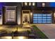 Contemporary home with desert landscaping, walkway lighting and glass panel garage door at 746 Horizon Canyon Dr, Henderson, NV 89052