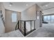 Hallway features modern railings, neutral colors, and bright lighting, creating an inviting and stylish transition space at 746 Horizon Canyon Dr, Henderson, NV 89052