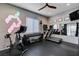 Well-equipped home gym with a stationary bike, treadmill, weight rack, and mirrored wall for effective workouts at 746 Horizon Canyon Dr, Henderson, NV 89052