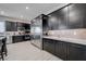Modern kitchen with stainless steel appliances, mosaic tile backsplash, and dark cabinetry at 746 Horizon Canyon Dr, Henderson, NV 89052