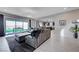 Spacious living room featuring an oversized sofa, modern decor, and sliding glass doors at 746 Horizon Canyon Dr, Henderson, NV 89052