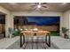Covered patio featuring a modern dining set, recessed lighting, and views of the landscaped backyard at 746 Horizon Canyon Dr, Henderson, NV 89052