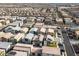 A high-angle shot highlights the organized layout of a dense residential area with varied home styles and ample parking at 7476 Opal Star St, North Las Vegas, NV 89084