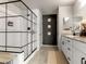 This bathroom features a sleek shower, granite countertops, and a unique accent wall at 7476 Opal Star St, North Las Vegas, NV 89084