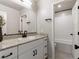 Bathroom featuring granite countertop vanity with a bathtub and white subway tiles in the background at 7476 Opal Star St, North Las Vegas, NV 89084