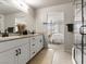 This is a primary bathroom with dual sinks, granite counters, and a view into the primary bedroom at 7476 Opal Star St, North Las Vegas, NV 89084
