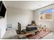 Bright bedroom space featuring exercise equipment on an ornate area rug, a window, and calming neutral walls at 7476 Opal Star St, North Las Vegas, NV 89084