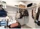 Neatly arranged walk-in closet with various clothing items and storage solutions at 7476 Opal Star St, North Las Vegas, NV 89084