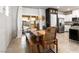 Charming dining area with a wooden table set, sliding doors to the patio, and modern decor at 7476 Opal Star St, North Las Vegas, NV 89084