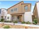 Charming two-story home featuring a modern exterior with a yellow front door and low maintenance landscaping at 7476 Opal Star St, North Las Vegas, NV 89084