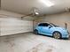 Spacious garage with epoxy flooring and a light blue car, offering ample parking and storage space at 7476 Opal Star St, North Las Vegas, NV 89084