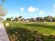Picturesque community green space with walking path, lush green lawn, and neighborhood homes at 7476 Opal Star St, North Las Vegas, NV 89084