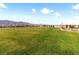 Expansive green space in residential area with mountain views, near modern homes and play areas at 7476 Opal Star St, North Las Vegas, NV 89084