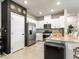 Modern kitchen with white cabinetry, stainless steel appliances, and a granite countertop island at 7476 Opal Star St, North Las Vegas, NV 89084