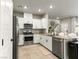 Modern kitchen with white cabinetry, stainless steel appliances, and a granite countertop island at 7476 Opal Star St, North Las Vegas, NV 89084
