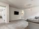 Spacious upstairs living room with carpeted floors, a comfortable sofa, and access to other areas at 7476 Opal Star St, North Las Vegas, NV 89084