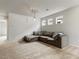 Cozy upstairs living area featuring a large sectional sofa, carpeted floors, and a modern lighting fixture at 7476 Opal Star St, North Las Vegas, NV 89084